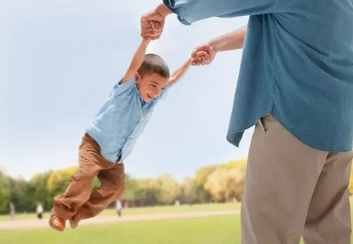 Teacher grabbing a child firmly by the arm